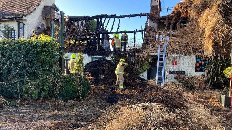 Damaged thatched roof and gutted building