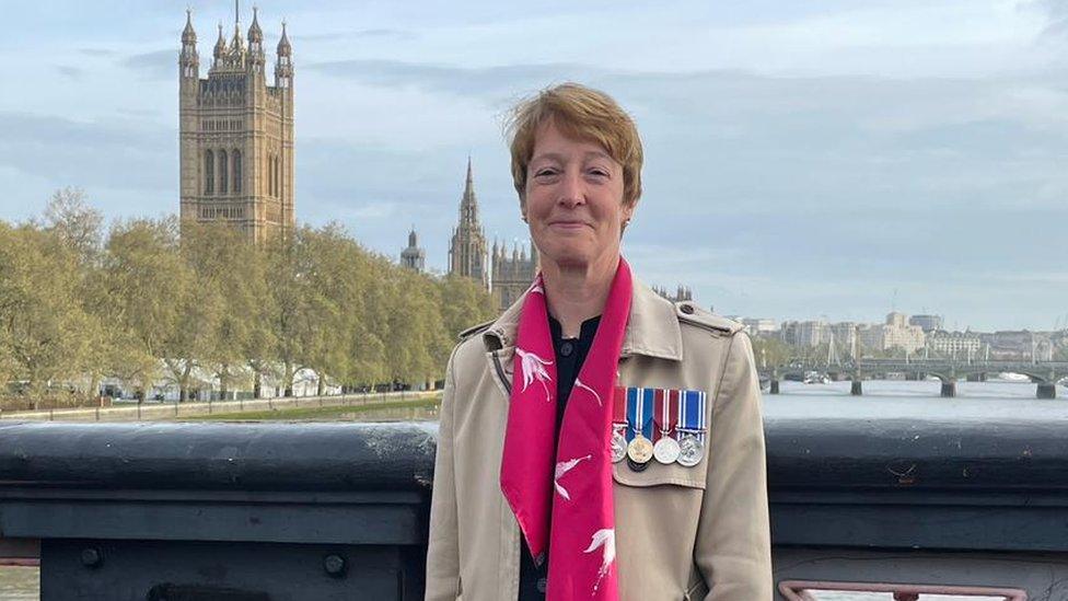 Nicky Perfect by the House of Commons wearing medals