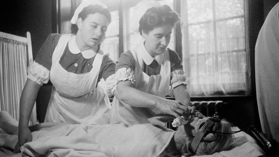 Nurses attending to a patient receiving electro-convulsive therapy to cure depression in 1946