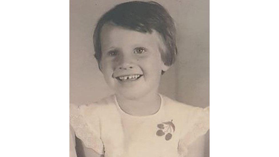 A black and white photo of a young girl