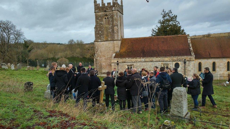 Mourners at a graveside