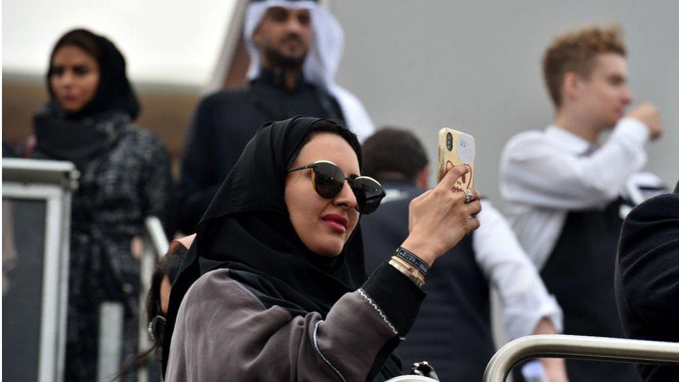 Saudi woman taking a photo