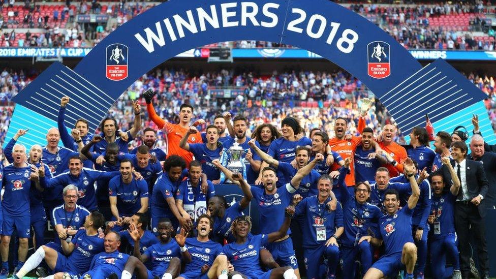 The Chelsea team with the Emirates FA Cup trophy following their victory over Manchester United at Wembley Stadium on May 19, 2018