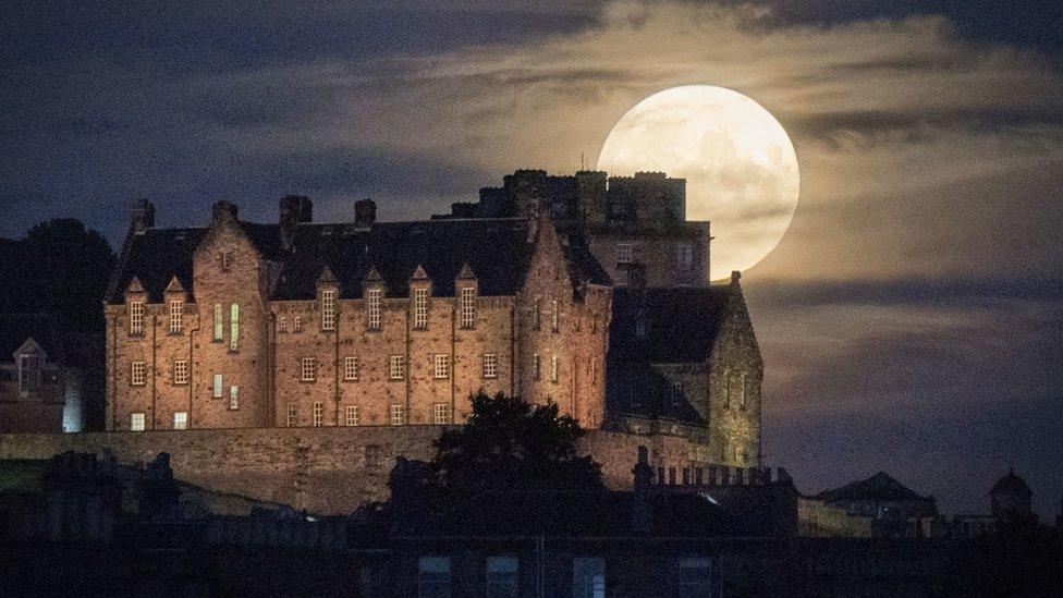 The July full moon, otherwise known as the Thunder Moon, above Edinburgh Castle.