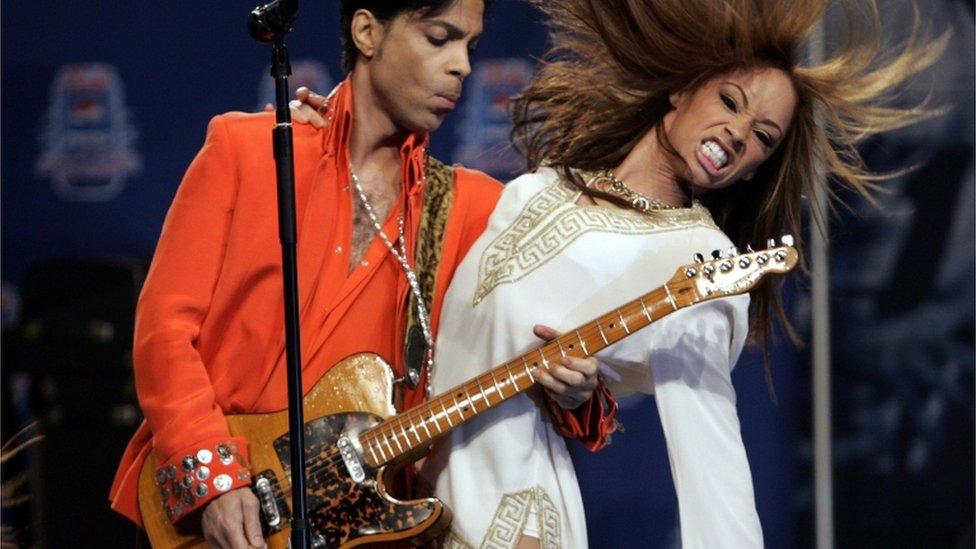 Musician Prince (L) performs for members of the news media in Miami Beach, Florida February 1, 2007.