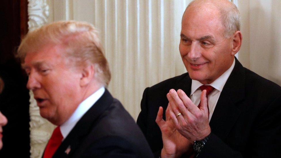 John Kelly (R) applauds as U.S. President Donald Trump arrives to hold a discussion at the White House (February 26, 2018)