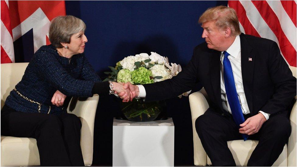 Theresa May and Donald Trump shake hands at Davos