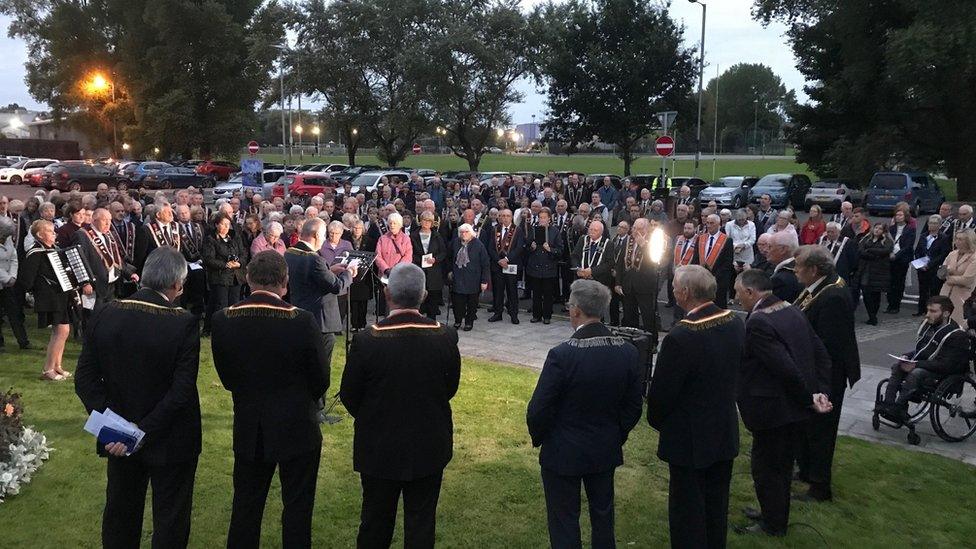 Large crowd gathered at Enniskillen Castle to observe the minute silence for the Queen