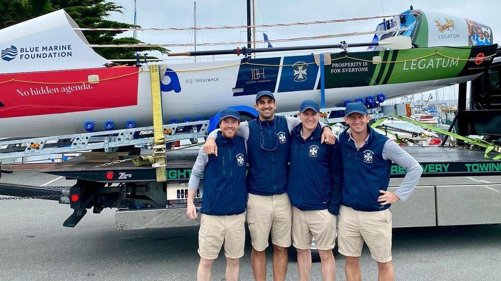 Brothers n Oars rowing team in front of their boat