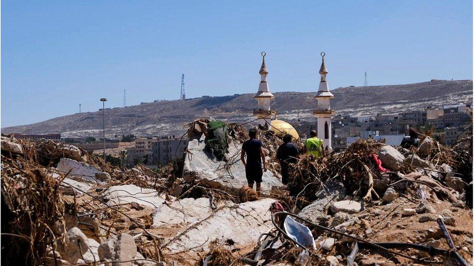 Rescue workers look through rubble