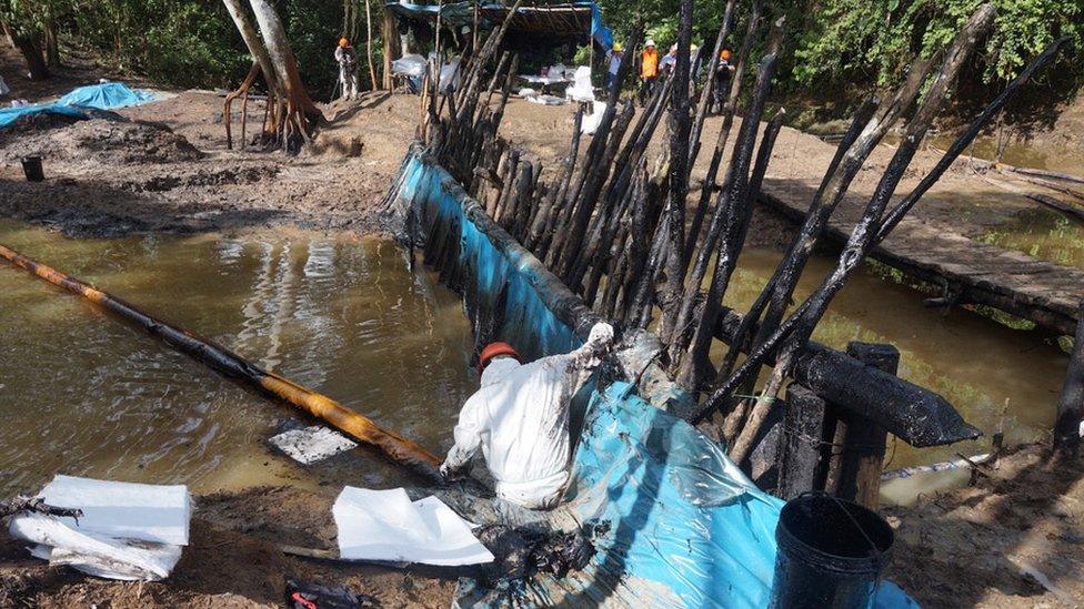 A man works on the clean-up of the contaminated river