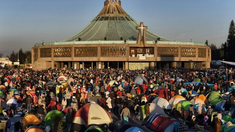 People gather around the Guadalupe Basilica during the feast of the Virgin of Guadalupe, patron saint of Mexico in Mexico City on December 12, 2017