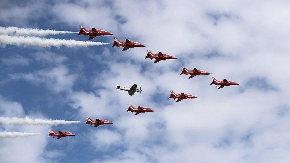 The Reds Arrows perform a flypast with a Spitfire at the start of the 2018 show