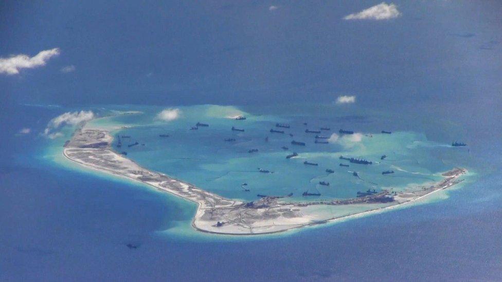 Aerial photograph shows an island and several ships