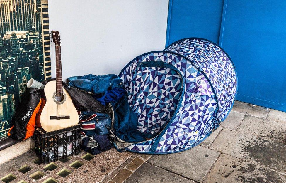 A homeless person in a tent