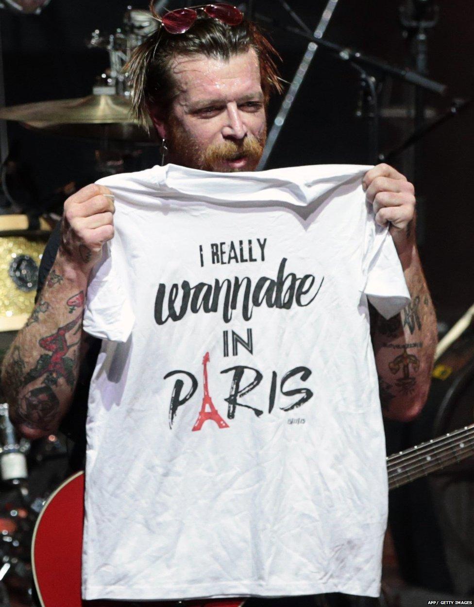 Jesse Hughes, the singer of Eagles of Death Metal, holds a t-shirt saying: I really wannabe in Paris