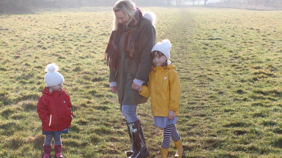 Molly Forbes with her children in a field