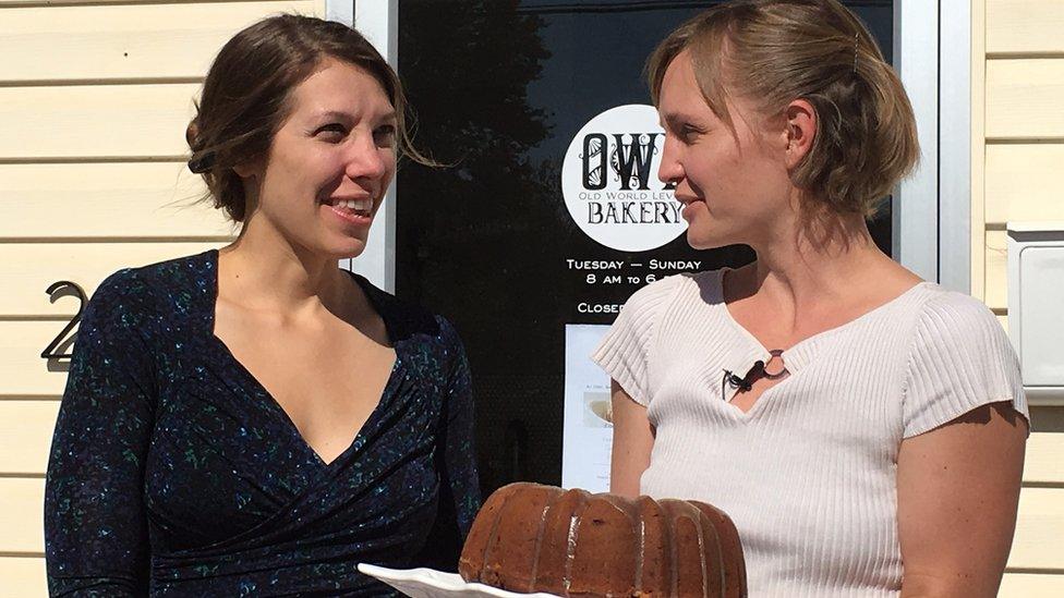 Susannah Gebhart (left) and Maia Surdam show off a freshly baked election cake