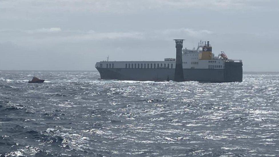 Cargo ship near lighthouse