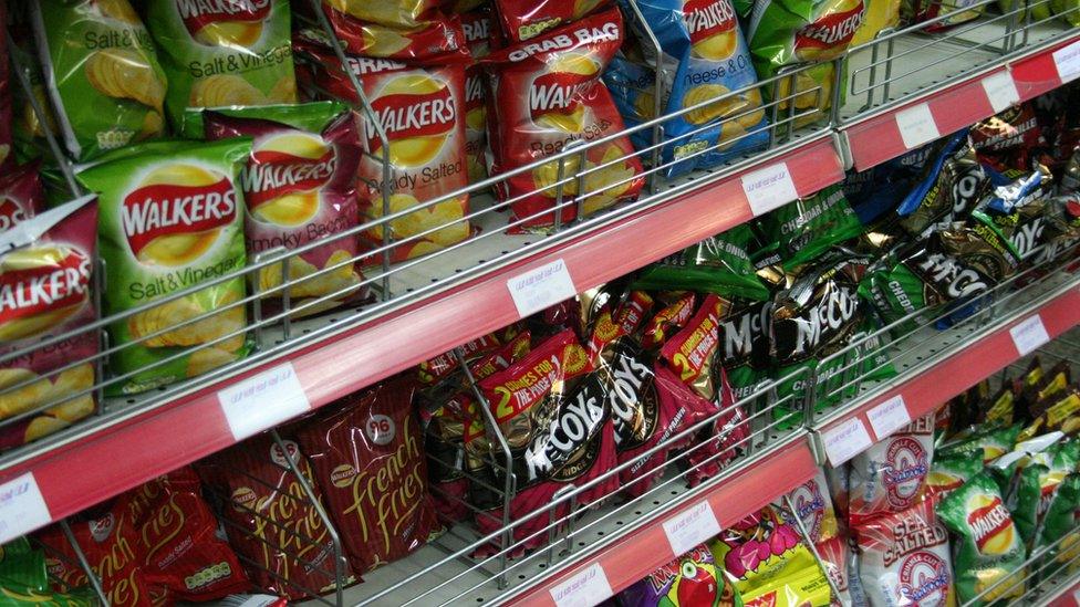 Supermarket shelves full of crisp packets