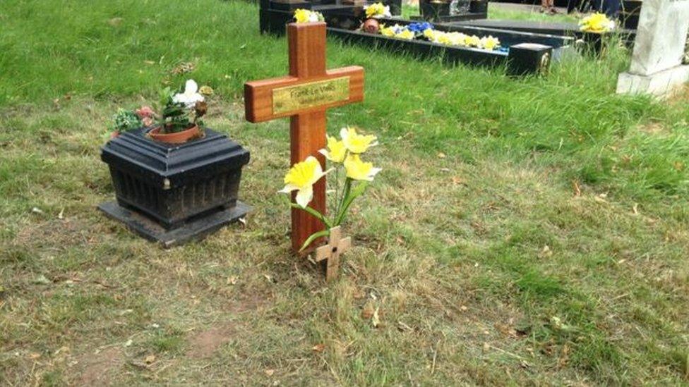 Cross laid on pauper's grave