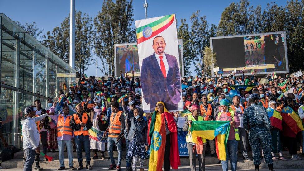 Demonstrators hold up a banner depicting Prime Minister Abiy Ahmed