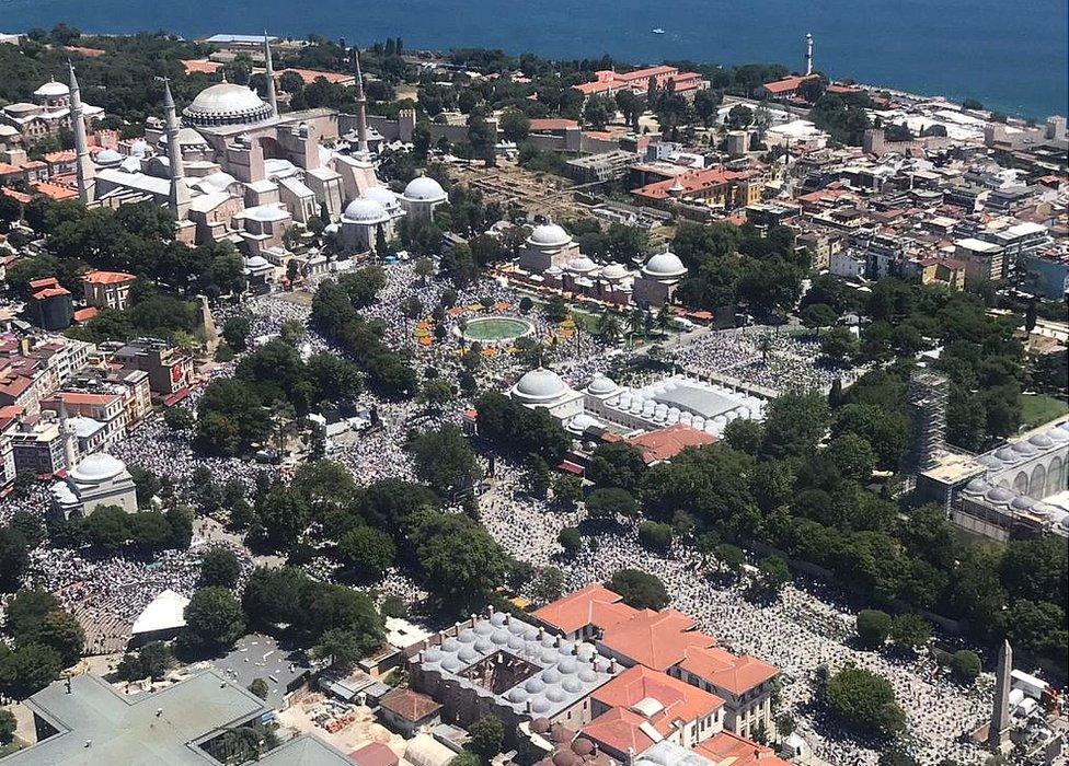 A drone photo shows people gathered around the Hagia Sophia Mosque