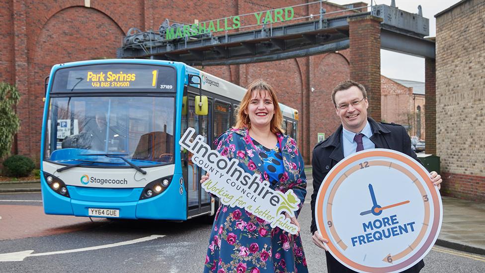 Councillor Clio Perraton-Williams in front of bus