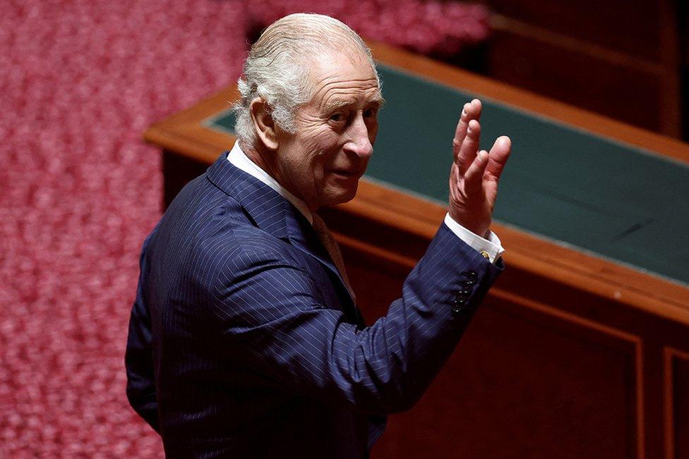 King Charles waves to members of parliament after he delivered his speech