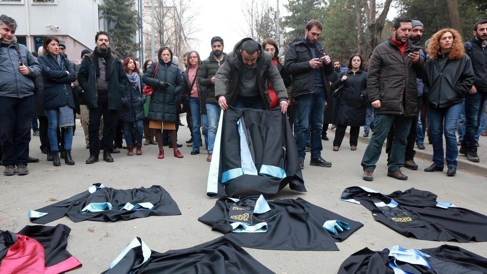 Academics lay down their gowns during a protest outside a university campus in Ankara (10 February 2017)