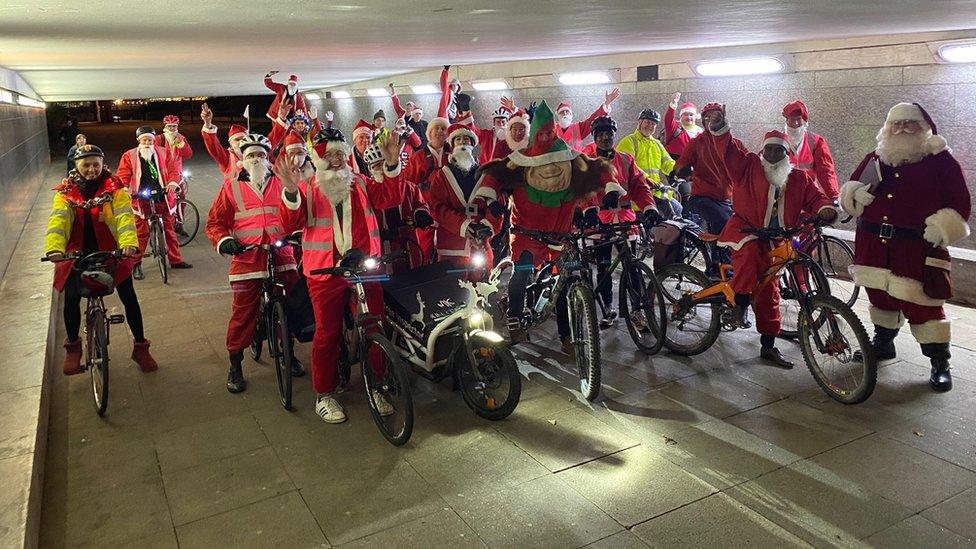 A group of Father Christmases on bikes