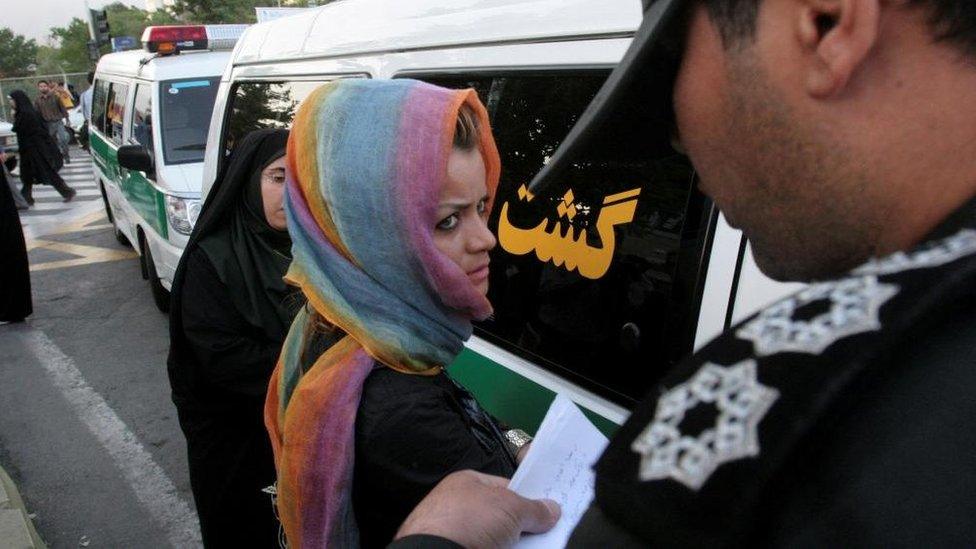 Iranian morality officer detains woman (file photo)