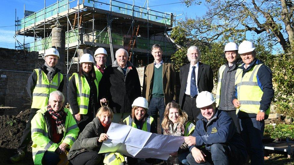 Conservation team in front of the West Mural Tower