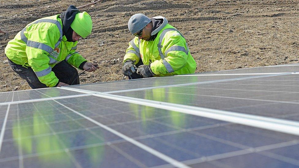 Technicians installing solar panels in Ohio