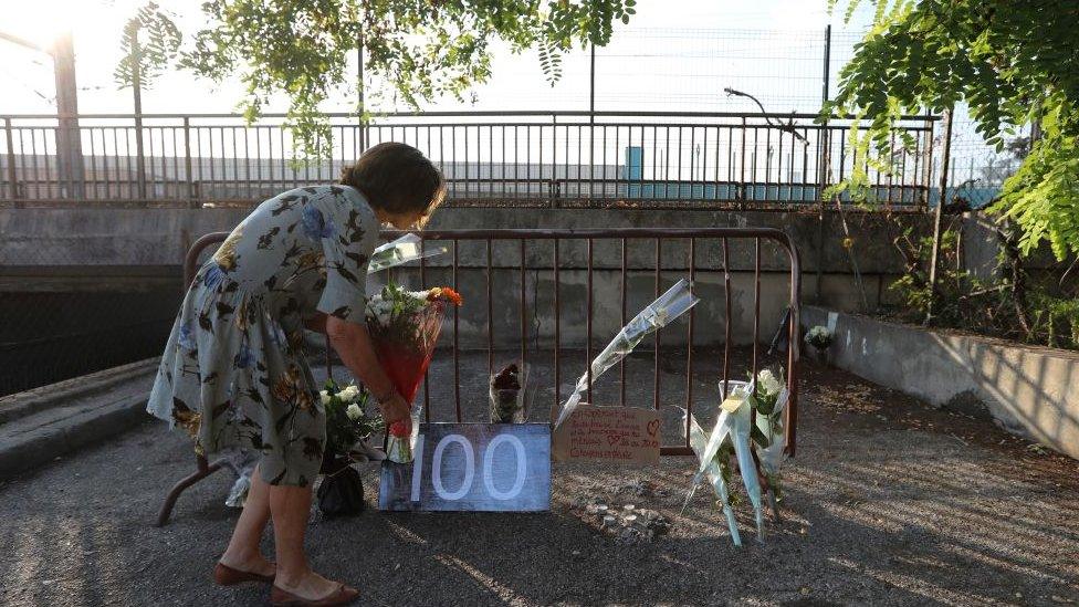 A woman placing flowers at the site where Salomé's body was found