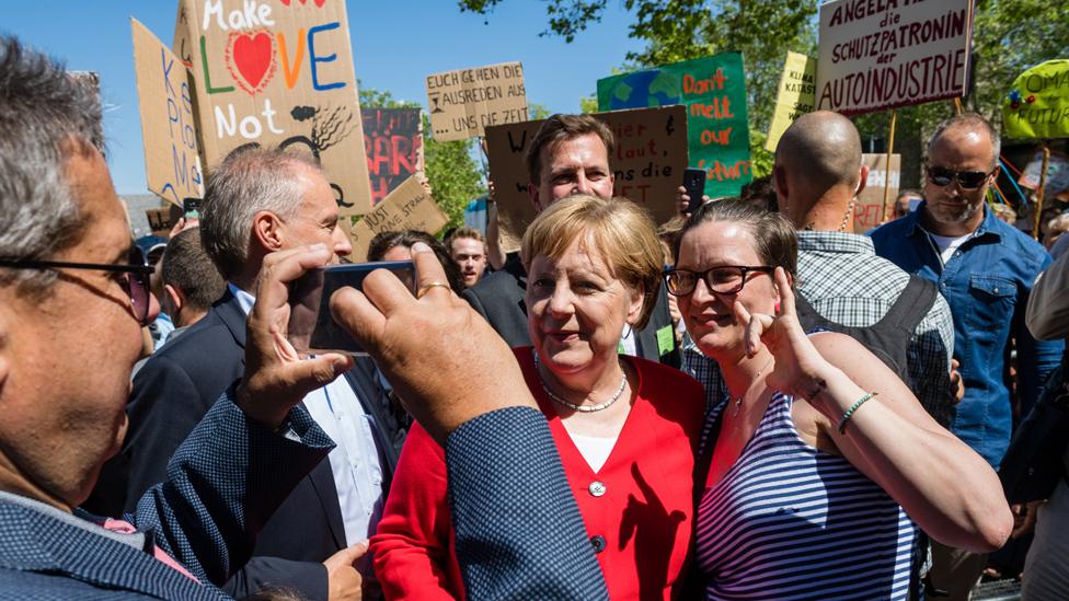 Merkel in Goslar, posing for a selfie