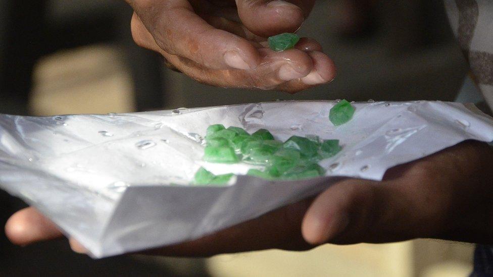 A trader inspecting jade at the gems and jade market in the northern Myanmar city of Mandalay