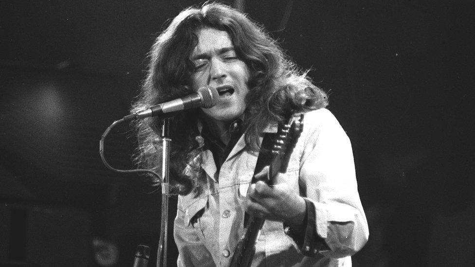 Rory Gallagher on stage at the Ulster Hall, Belfast, in 1977