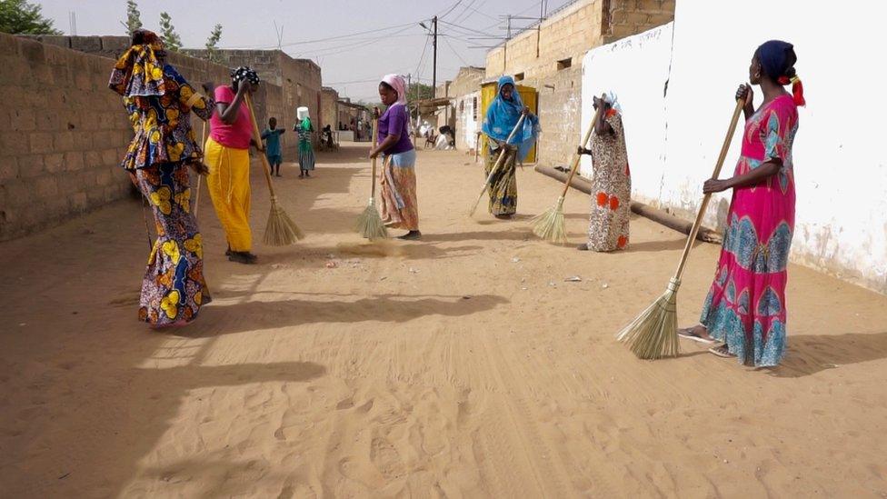 Women sweeping