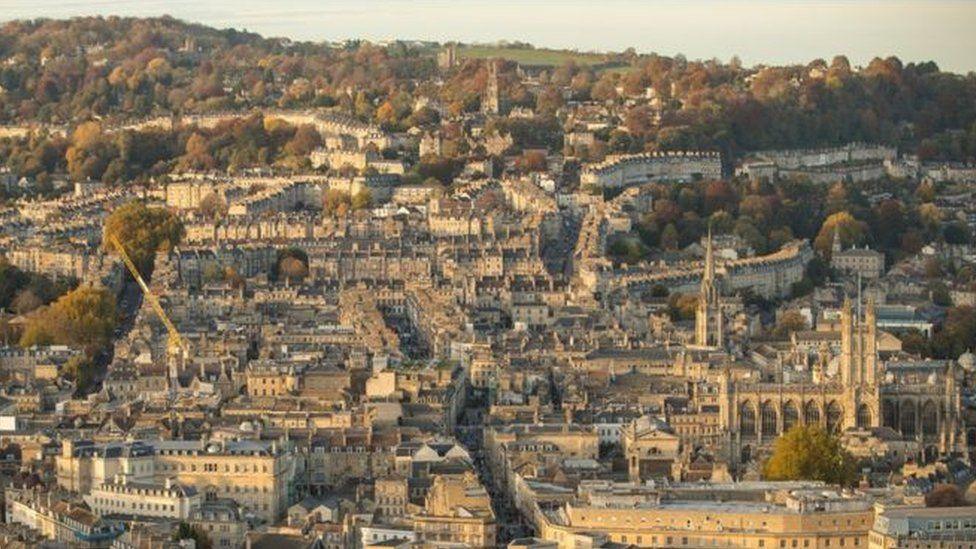 A wide view looking down over Bath city centre showing spires and rooftops