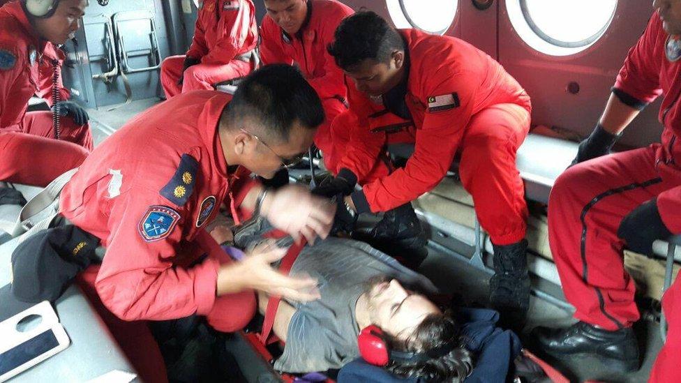 Rescuers attend to Andrew Gaskell, an Australian tourist who has been missing in Malaysia for nearly two weeks