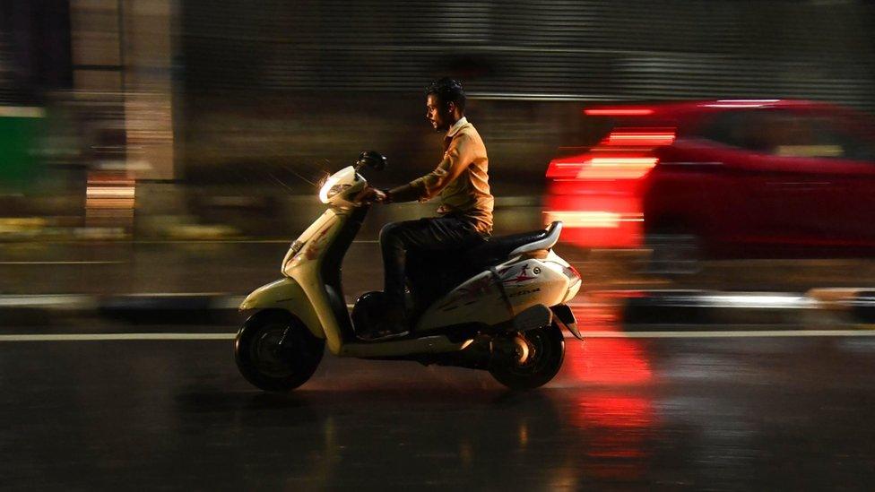 A man riding a bike without helmet