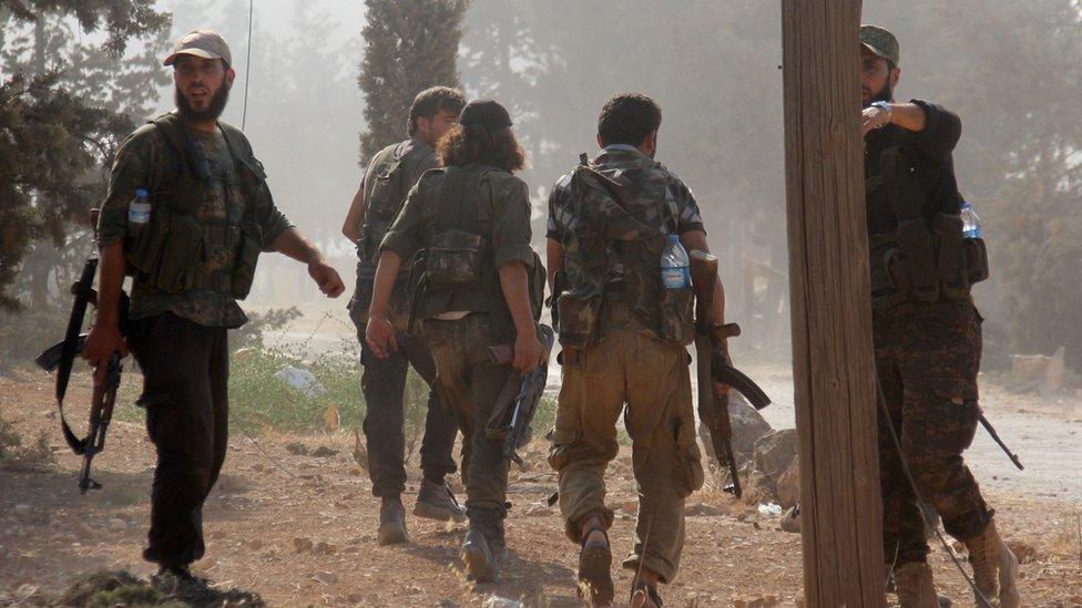 Fighters from Jabhat Fateh al-Sham advance on a road south of Aleppo on August 6, 2016