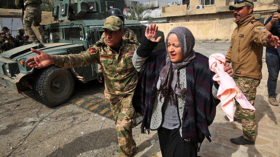 An Iraqi woman flees Mosul during an Iraqi forces offensive to retake the area from IS