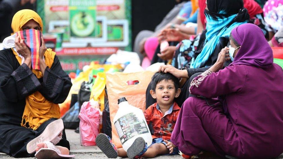 People waiting to buy kerosene in Colombo.