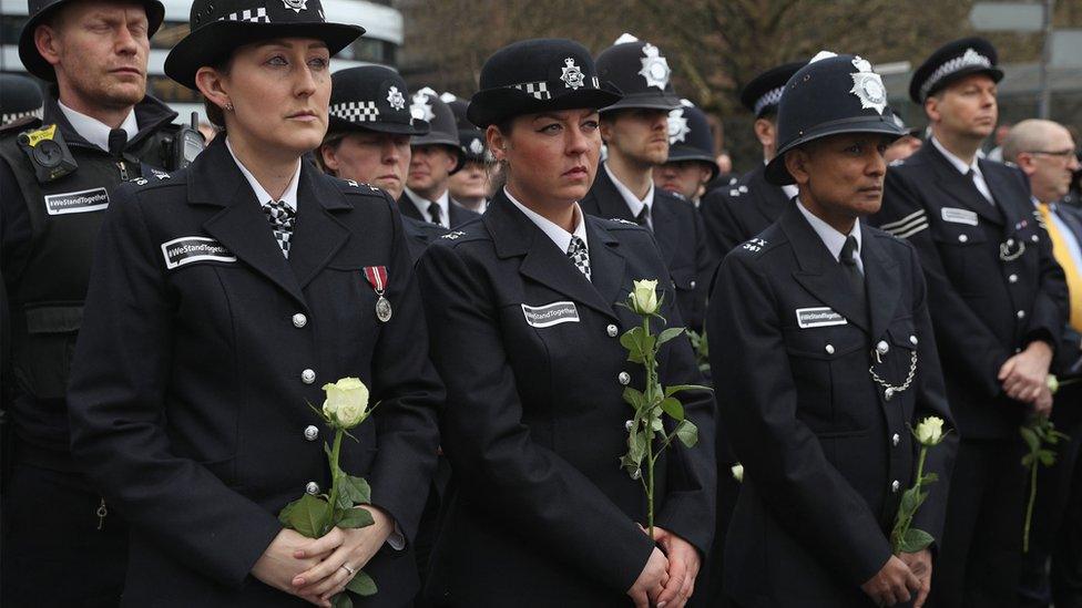 Police officers joined the crowds in remembering the victims of last Wednesday's attack