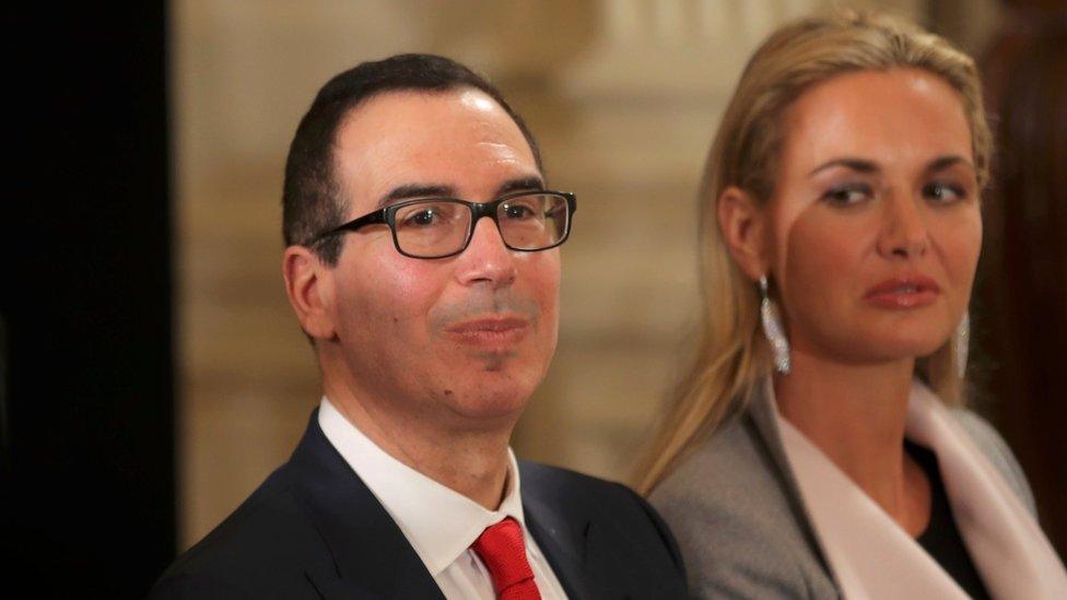 Treasury Secretary nominee Steven Mnuchin sits with Vanessa Trump (R), wife of Donald Trump Jr, before a swearing-in ceremony for senior staff at the White House in Washington, DC January 22, 2017