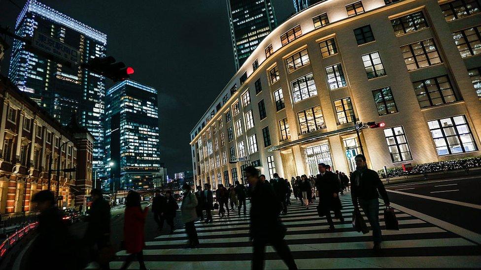 Pedestrians cross the street in downtown Tokyo