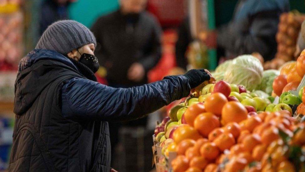 Woman buying fruit and vegetables