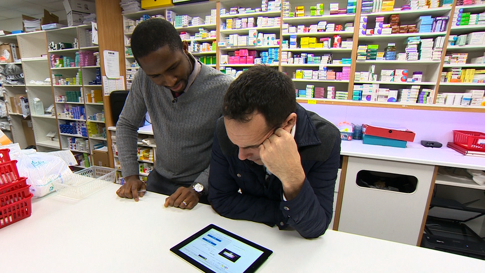 Reporter and pharmacist look at drugs on eBay